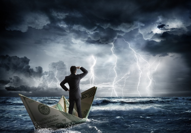 Business man standing on a boat approaching a storm