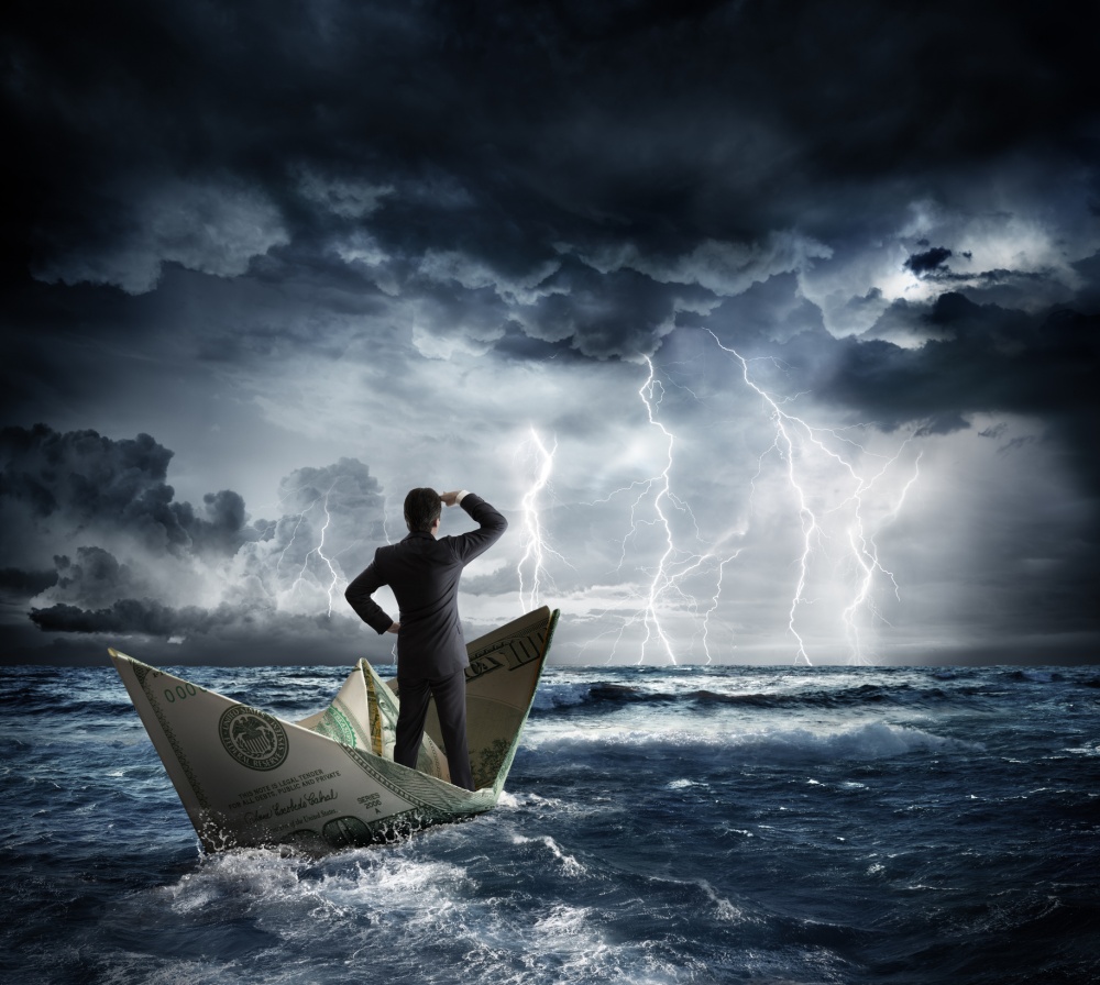 Business man standing on a boat approaching a storm